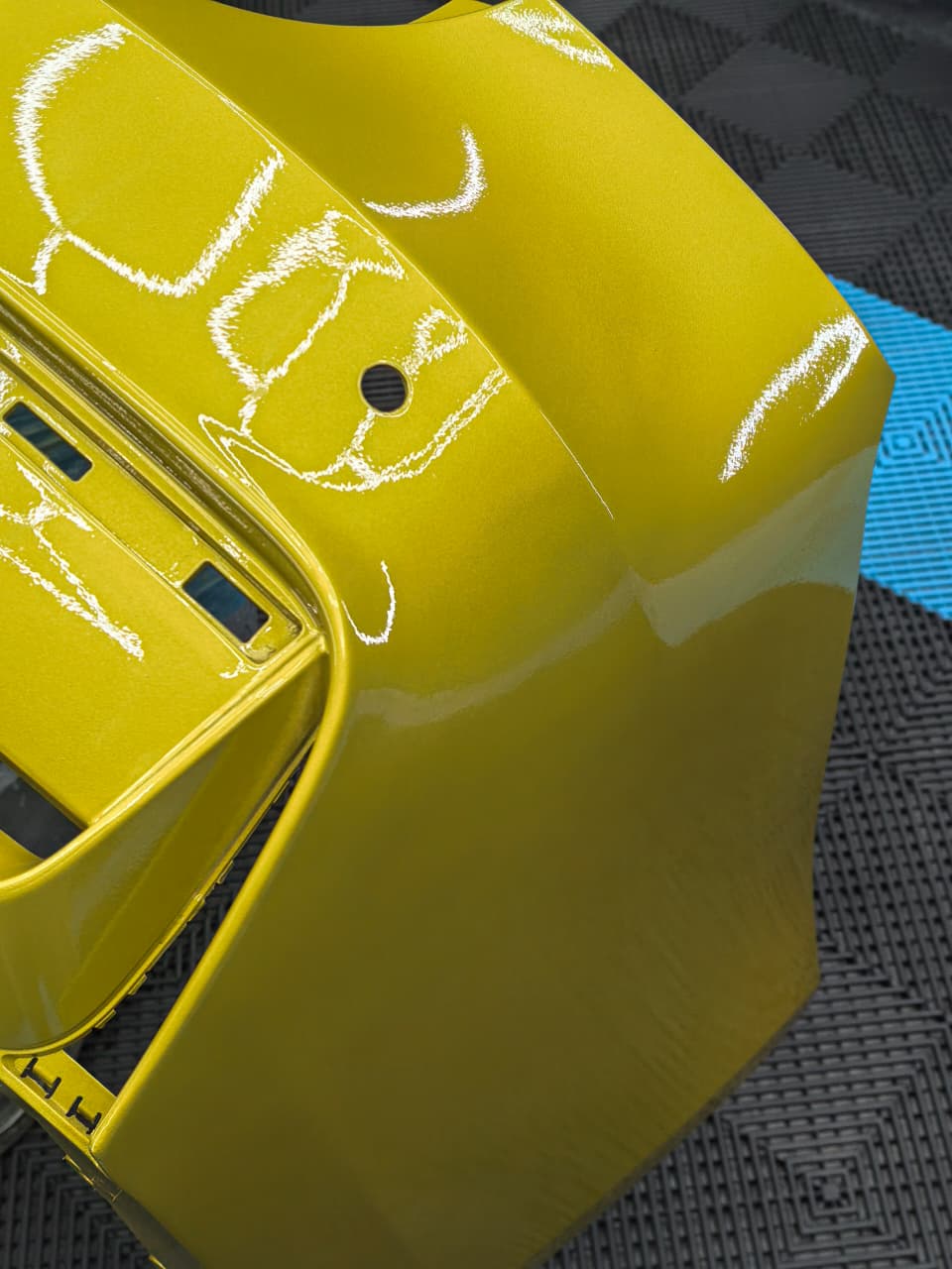Yellow plastic bumper repair in progress at AutoHub
