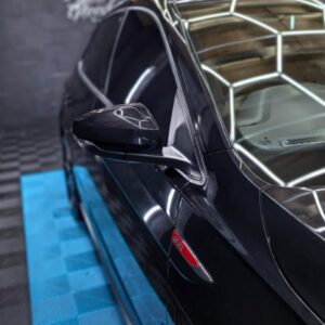 Black vehicle side mirror and door detail after polishing