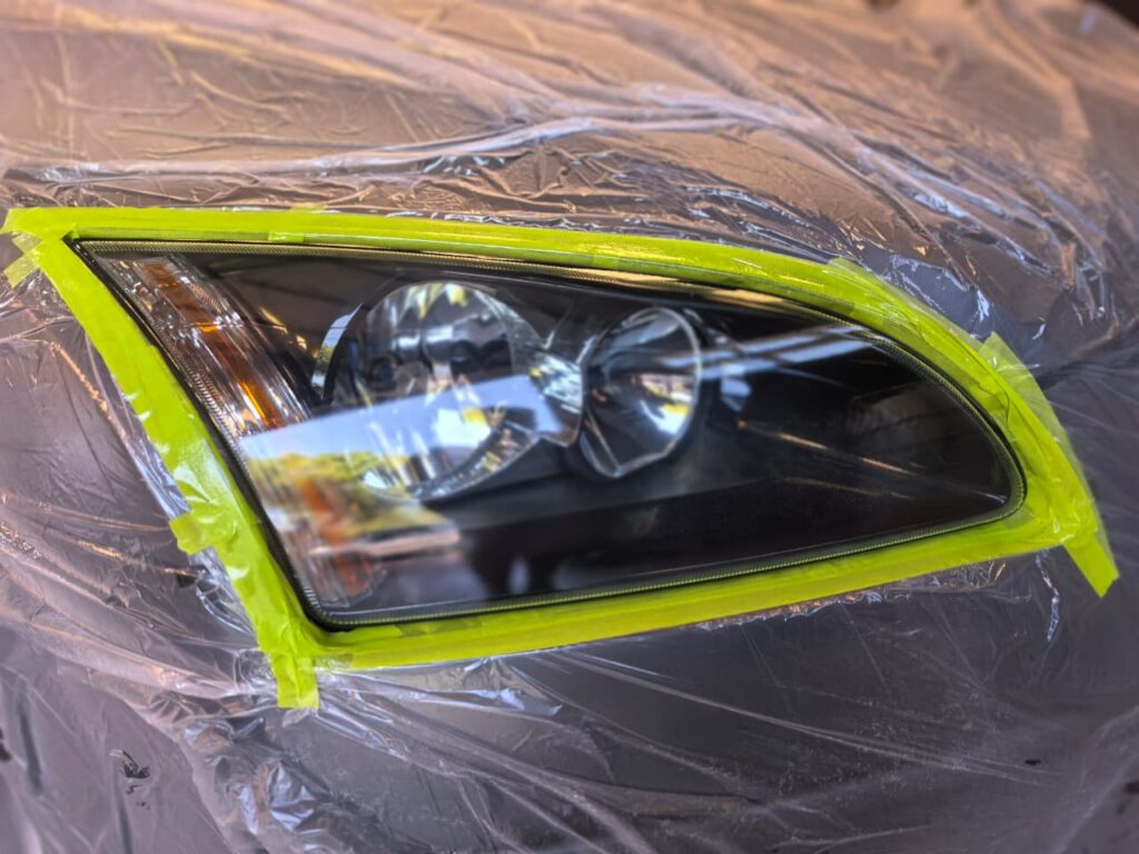 Headlight Restoration showing yellow vehicle bumper at AutoHub in Observatory, Cape Town
